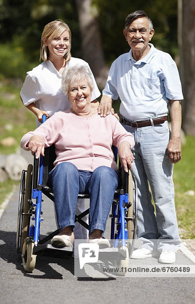 Nurse pushing senior woman in a wheelchair
