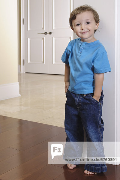 Portrait of a Young Boy Standing against a Door Frame  Toronto  Ontario