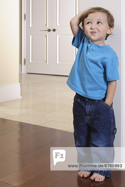 Young Boy Measuring his Height against a Door Frame  Toronto  Ontario