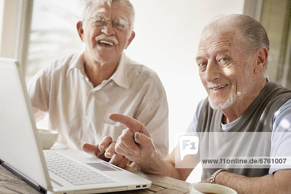 Senior men using laptop