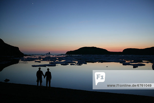 Silhouette of a Couple Holding Hands at Sunset  Twillingate  Newfoundland