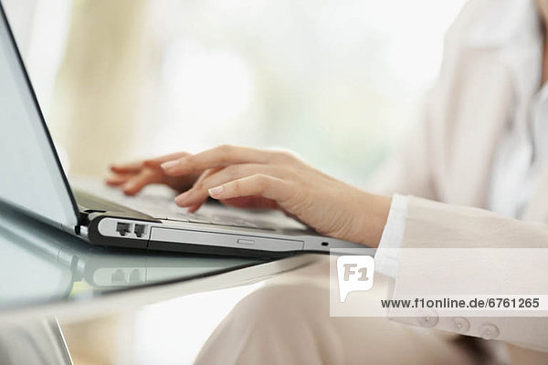 Close-up of businesswoman using laptop