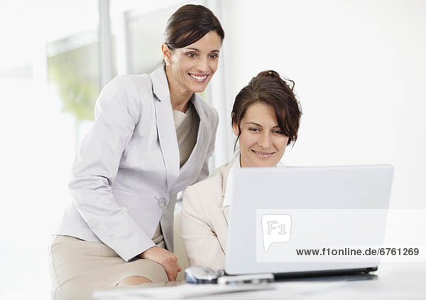 Female office workers using laptop