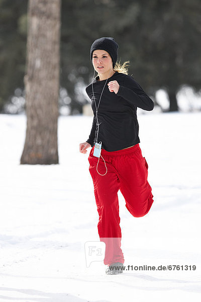 Young Woman Jogging in Winter  Prince's Island Park  Calgary  Alberta