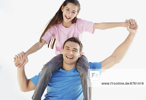 Father carrying daughter (10-11) on back