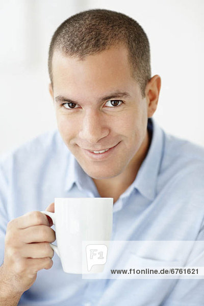 South Africa  Portrait of smiling man holding mug
