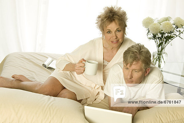 Mature Couple Sitting in Bed with a Laptop  Toronto  Ontario