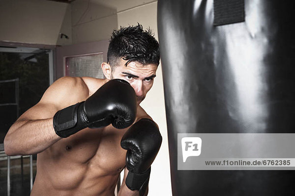 USA  Seattle  Portrait of young man boxing in gym