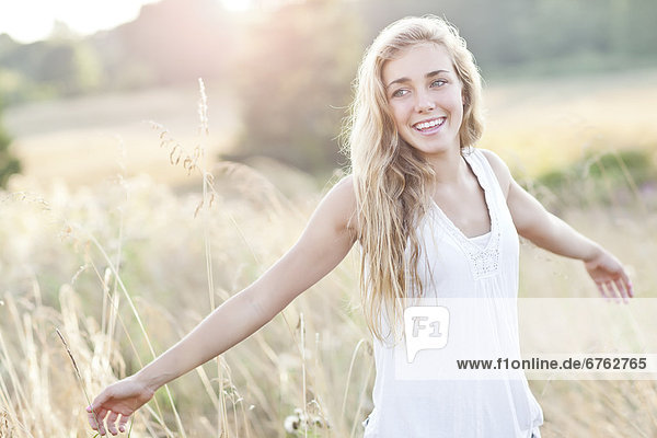 Happy teenage girl (16-17) enjoying bright sunshine