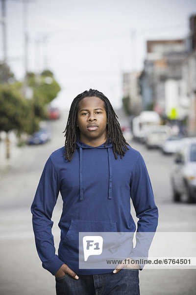 Portrait of teenage boy (16-17) walking in street  San Francisco  California  USA