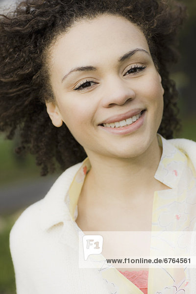Portrait of young woman smiling  outdoors