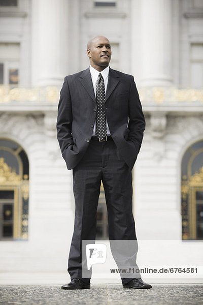 Businessman standing outside office building  San Francisco  California  USA