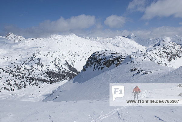 Skier heading to base of unnamed summit  Marriot Basin area  Coast Mountains  British Columbia