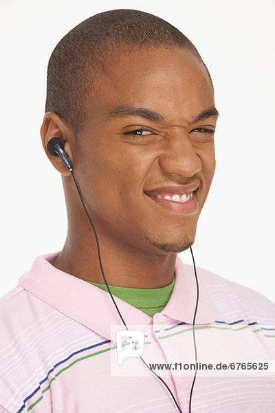 Man wearing earphones making a funny face