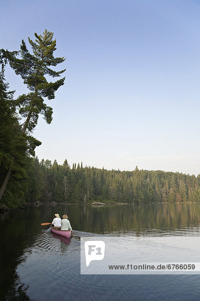 Canoeists paddling  Smoke lake  Algonquin Park  Ontario
