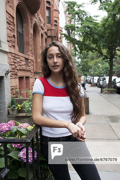 USA  New York  New York City  Portrait of young woman standing on street