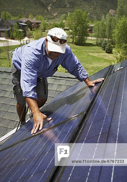 Dach bauen arbeiten installieren Sonnenkollektor Sonnenenergie Tisch