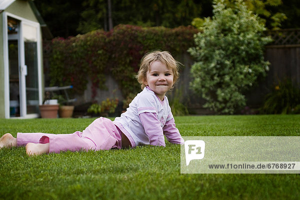 Little Girl Laying in Grass in Backyard Langley BC