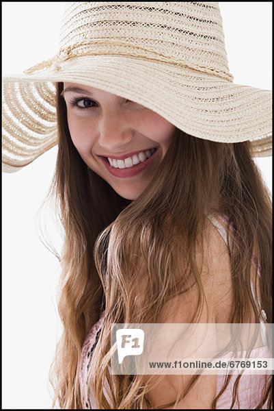 Smiling long haired woman wearing a straw hat