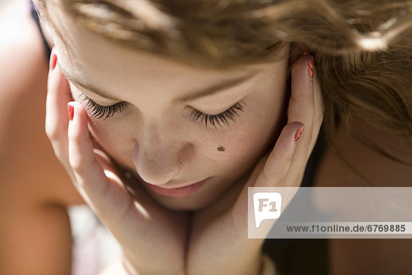 Close Up of Teenage Girl with Face in Hands  Vancouver  British Columbia