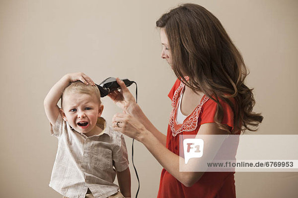 USA  Utah  Lehi  mother shaving son's (18-23 months) head