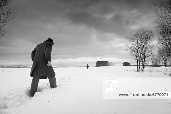 Man in Coat and Hat Walking through Snow  Winnipeg  Manitoba