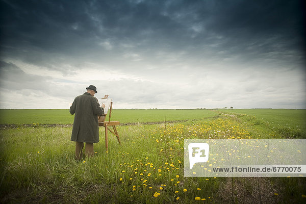 Man in Hat and Coat Painting in Field  Winnipeg  Manitoba