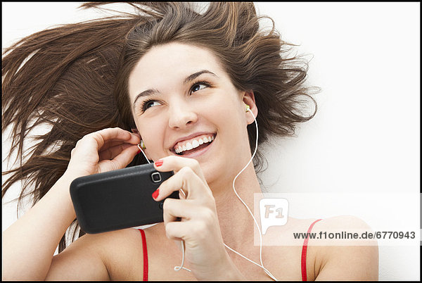 Young woman listening to mp3 player