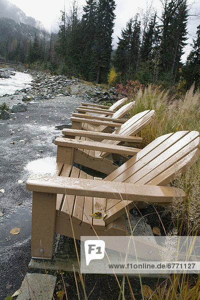 Muskoka chairs in the rain along Fitzsimmons Creek  Rebagliati Park  Whistler  British Columbia