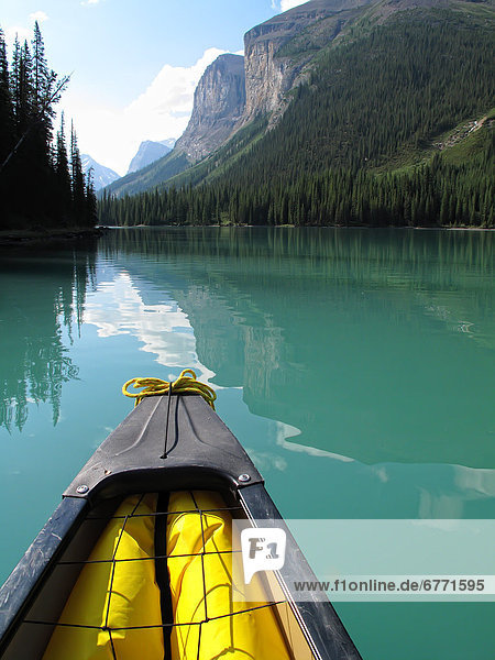 The front of a canoe heading into the Narrows in Maligne Lake  Jasper National Park  Alberta