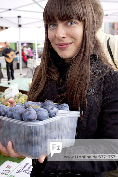 Artist's Choice: Woman at a local farmers market holding plums  Toronto  Ontario