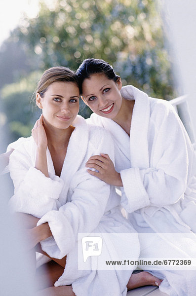 Two woman wearing bath robes