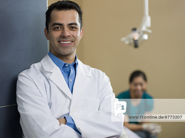 Portrait of dentist  dentist and patient in background