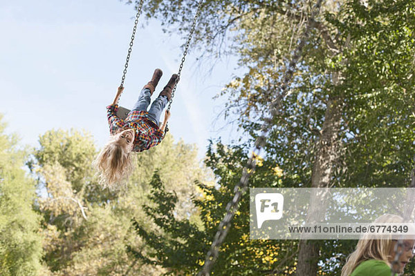 USA  Utah  girl (6-7)swinging on tree swing