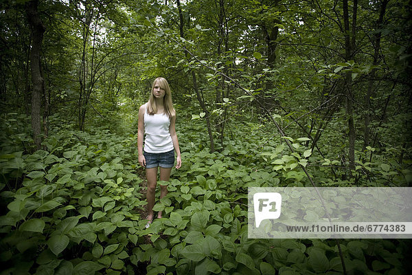 Girl in standing in a forest  Winnipeg  Manitoba