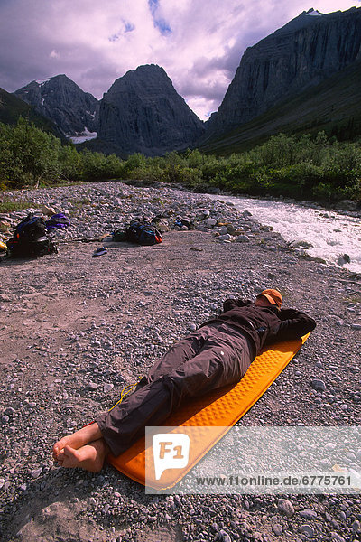 Hiker Taking a Nap during a long trip around Mount MacDonald  Mayo  Yukon