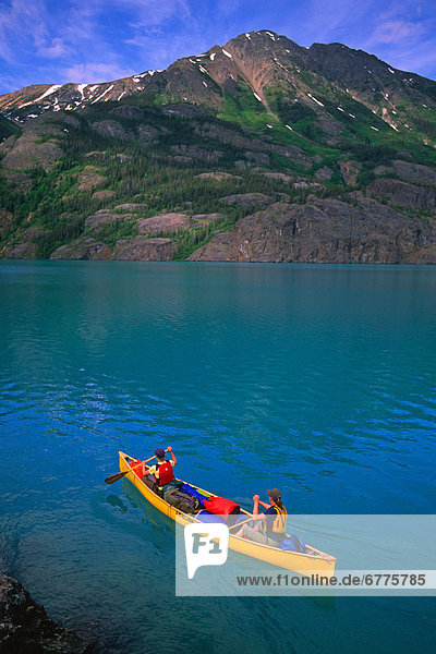 Canoeists Paddle along the Shore of Atlin Lake  Atlin  British Columbia