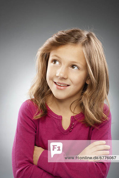 Studio portrait of girl (10-11) smiling