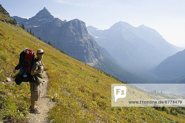 USA  Montana  Glacier National Park  Browns Pass  Mid adult hiker posing