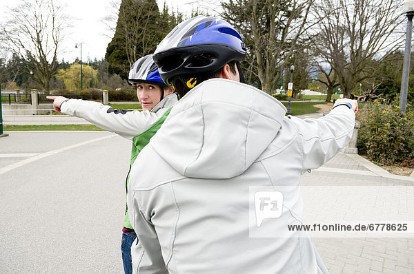 Couple Riding Tandem Bike Pointing in Different Directions  Vancouver  British  Columbia