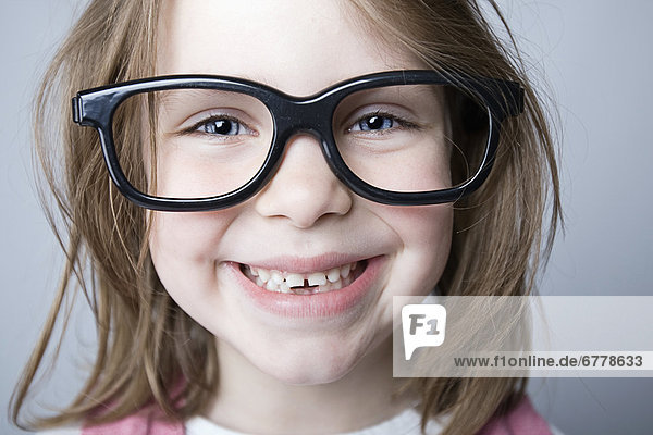 Studio portrait of girl (6-7) wearing big glasses