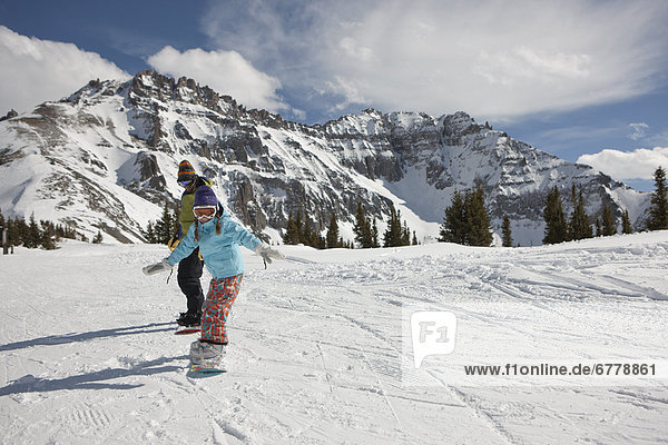 USA  Colorado  Telluride  Father and daughter (10-11) snowboarding