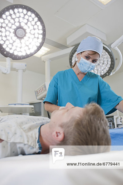 Surgeon preparing patient for surgery