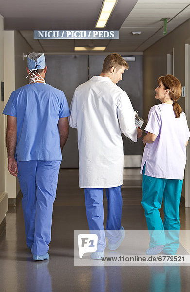 Doctors and surgeons walking in corridor