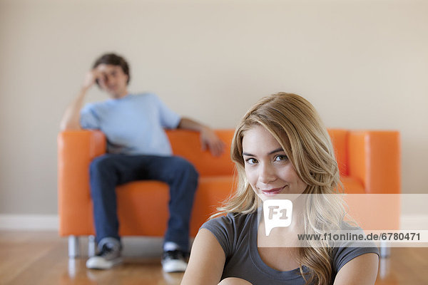 Young couple in room  focus on woman in foreground