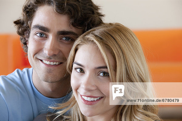 Portrait of young couple in room