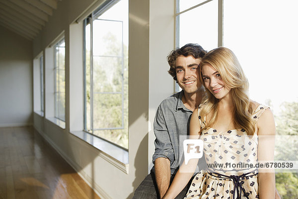 Portrait of young couple in empty home