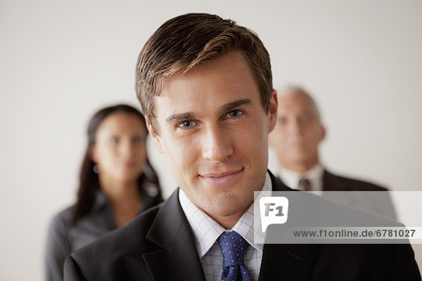 Studio shot of business people  focus on young business man