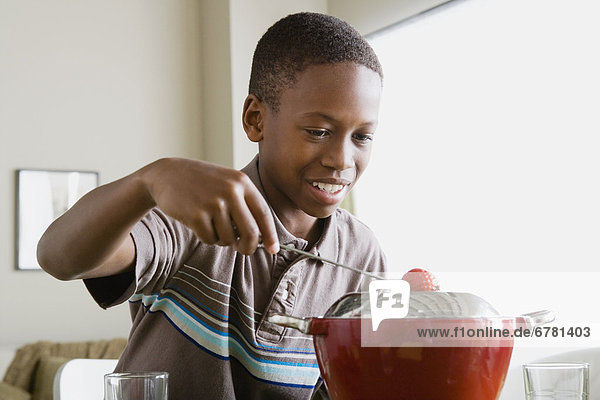 Boy (12-13) preparing dessert