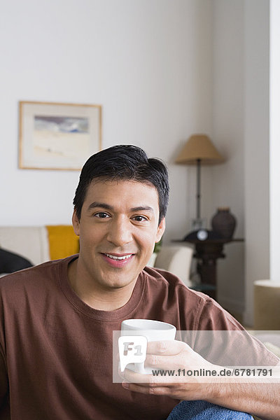 Close up of smiling man holding cup